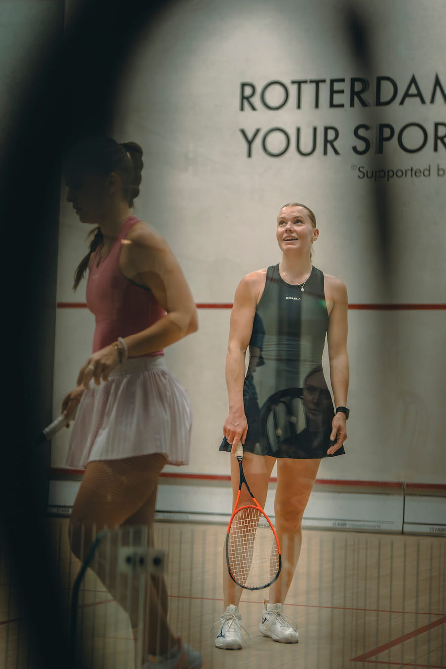 Two women on a squash court in Dessard